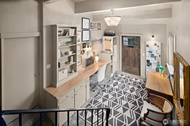 Versatile bonus room with vaulted ceiling, boxed beams, and doors leading to attached garage and side yard