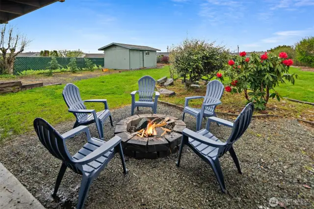 Enjoy your private backyard surrounded by mature landscaping by roasting marshmallows around the fire pit.