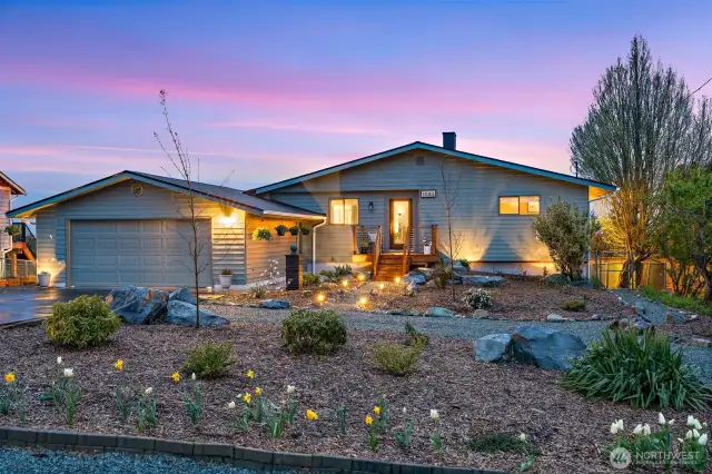 Thoughtfully landscaped front yard at twilight