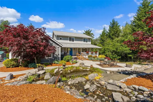 Beautiful Front view, with river leading to fish pond. Mature landscaping.