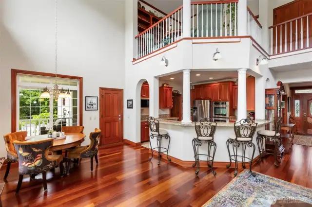 The kitchen boasts both breakfast bar and additional informal dining areas with access to the covered porch areas.