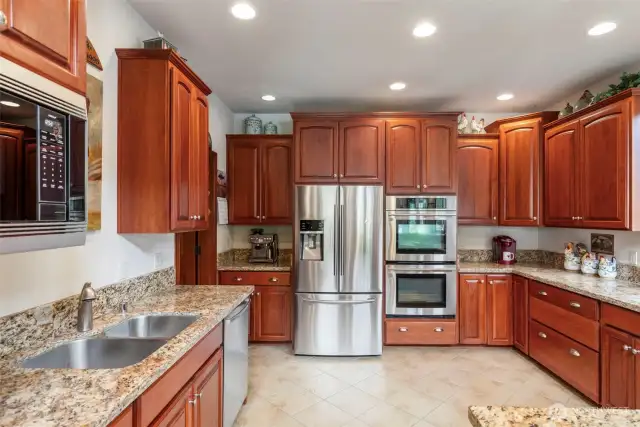 The gourmet kitchen is a chef's delight with double ovens and all stainless steel appliances.