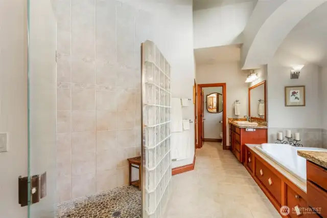 From the shower end, looking towards the soaking tub and separate vanity.