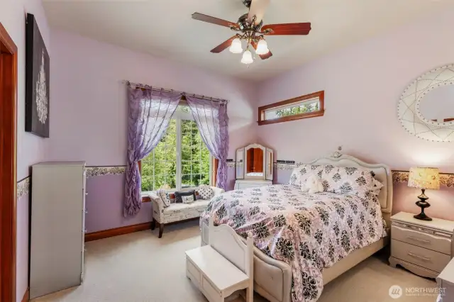 Large bedrooms with high ceilings are connected by a jack and jill bathroom.