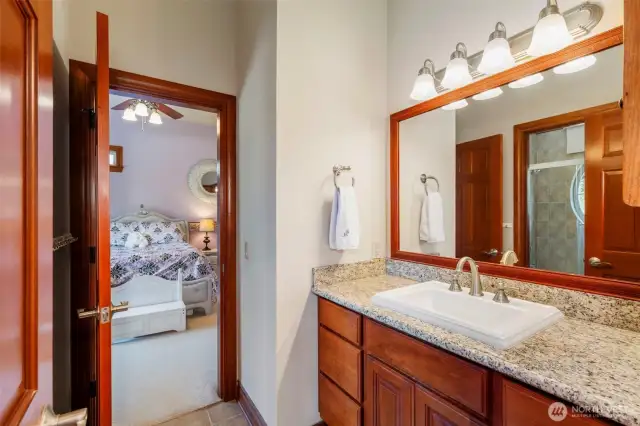 The jack and jill bathroom is expansive with tall ceilings, full bath & clerestory window.