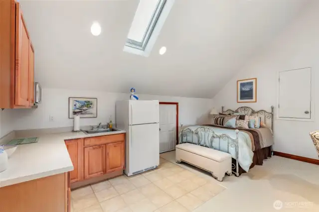 Upstairs mother in law apt enjoys vaulted ceilings, mini kitchen, private 3/4 bath and loads of storage in attic areas.