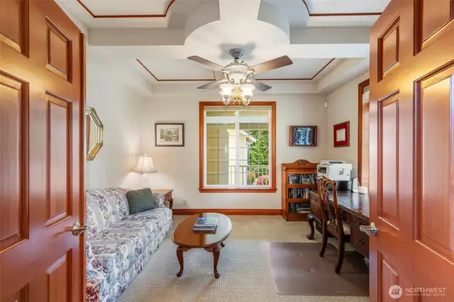 Unique ceiling design in the large den off the foyer through french doors.