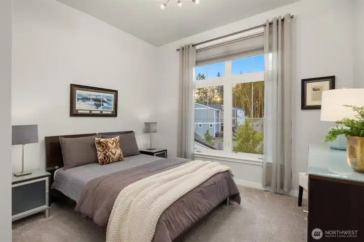 One of 4 bedrooms on the 2nd floor, this room offers a partially vaulted ceiling and large picture window.