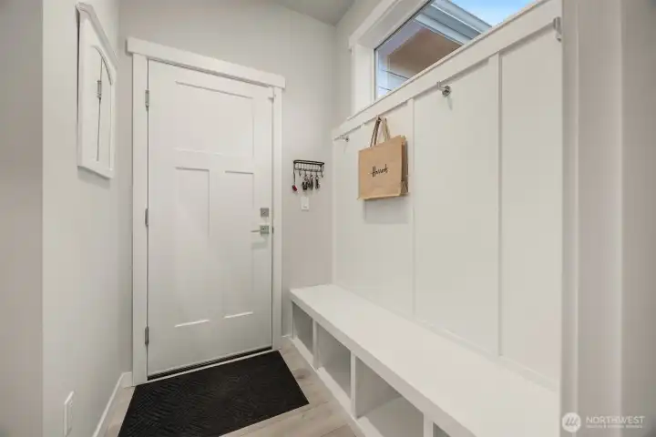 Access to and from the garage is a breeze with a built in bench, with storage underneath and hooks for hanging coats & bags above.