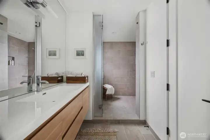 The shared upstairs bathroom has a private water closet and a huge walk in shower