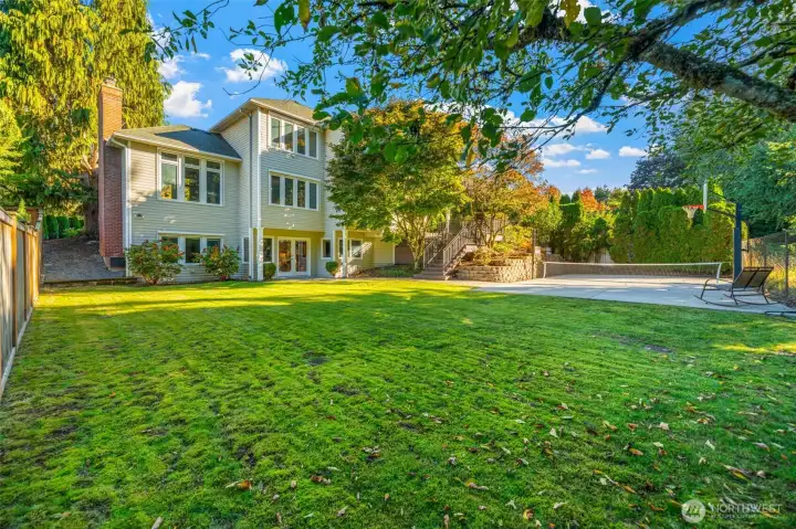 Large level yard with sport court.