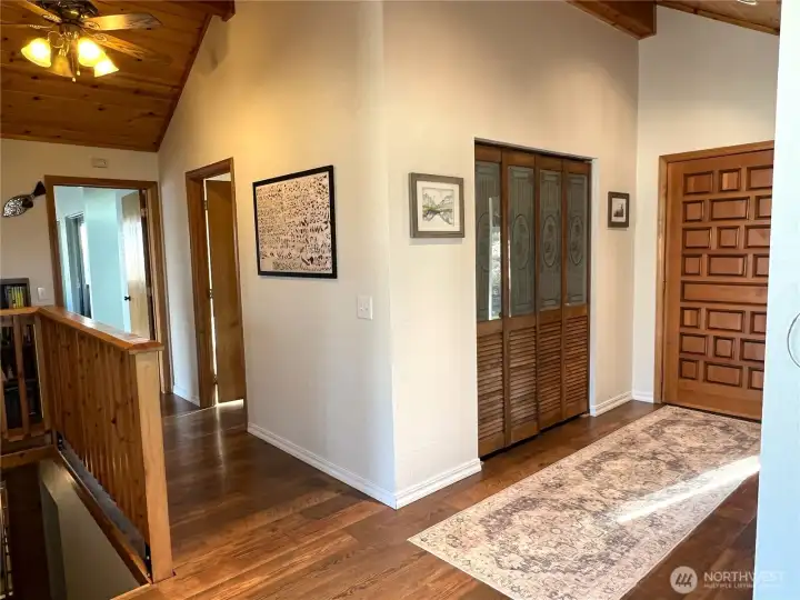 Vaulted ceilings and beautiful woodwork in entry way