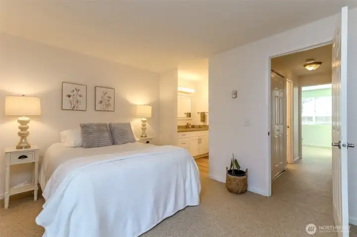 Primary bedroom features access to full bath with its own private vanity area.