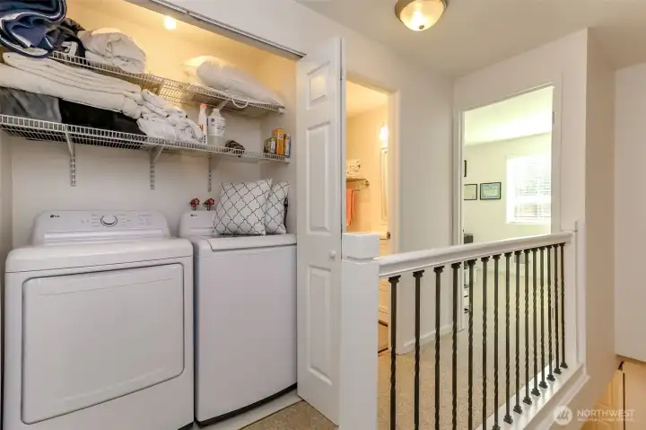 Laundry area located on upper level is discretely tucked away being closet doors.