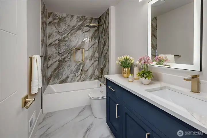 Modern fixtures and flawless finishes in this central hallway bath