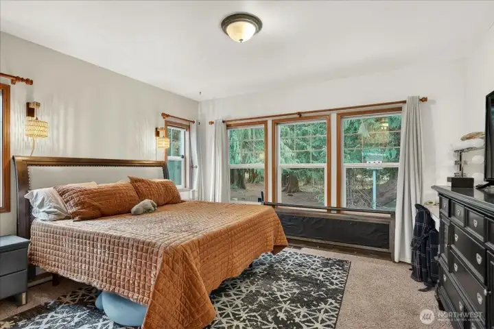 Unit A - Spacious primary bedroom with with WIC, full bathroom & lots of natural light.