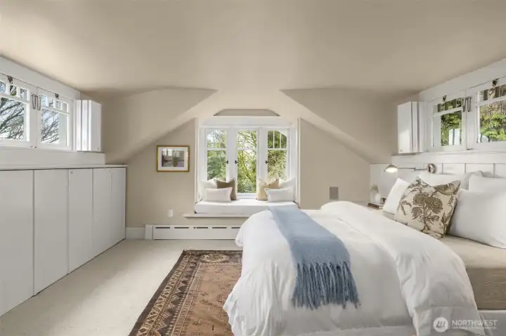 The primary bedroom has a window seat with mountain and lake views.