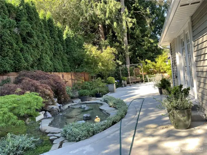 View of patio in summer.  Swing will stay with home.