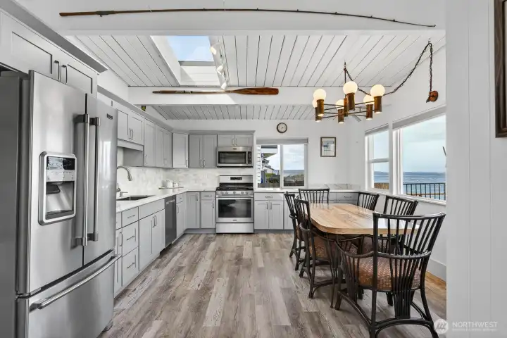 Huge kitchen with stainless Maytag appliances. Quartz counters, skylight, undercounter lighting. Cabinets are soft close and there are drawer pull outs in cabinets.