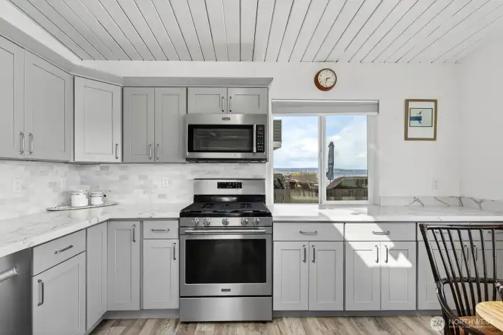 Gas cook top stove and overhead microwave.