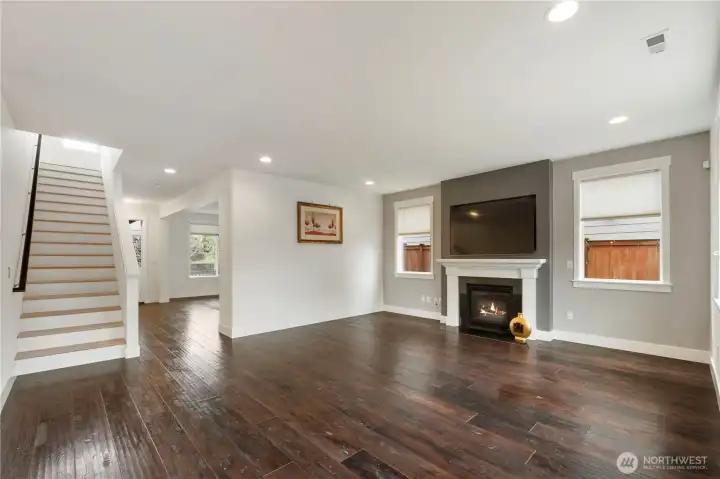 living room featuring a fireplace, large windows