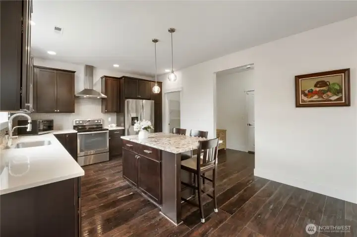 Kitchen with a generous center island and stainless steel appliances