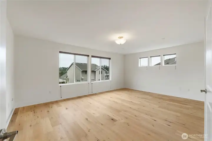 Spacious primary bedroom with abundant natural light