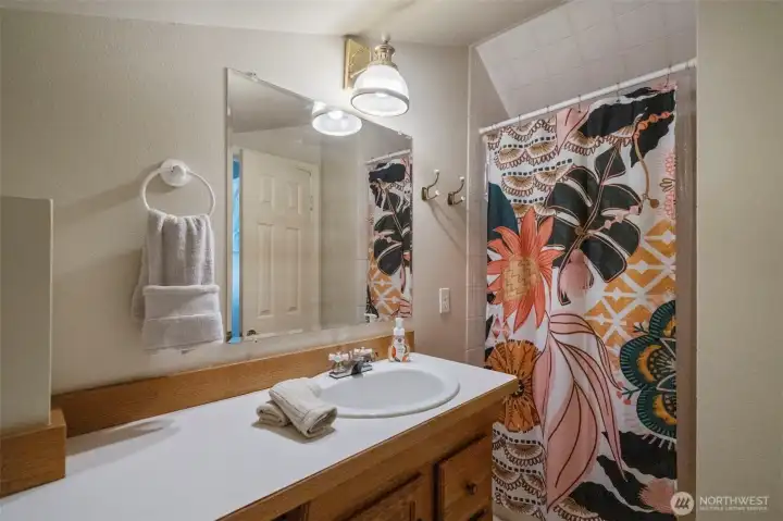 The loft is complemented by a full bathroom, an ideal setup for guests or extended living.