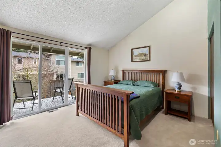 Primary bedroom with vaulted ceiling.