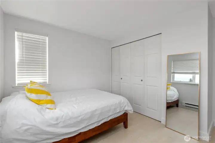 Bedroom closet features built-in storage system.