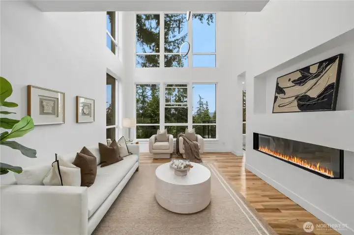 Dramatic two-story great room showcasing soaring ceilings and a stunning wall of oversized windows