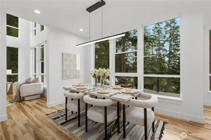 The dining area is framed by expansive south-facing windows