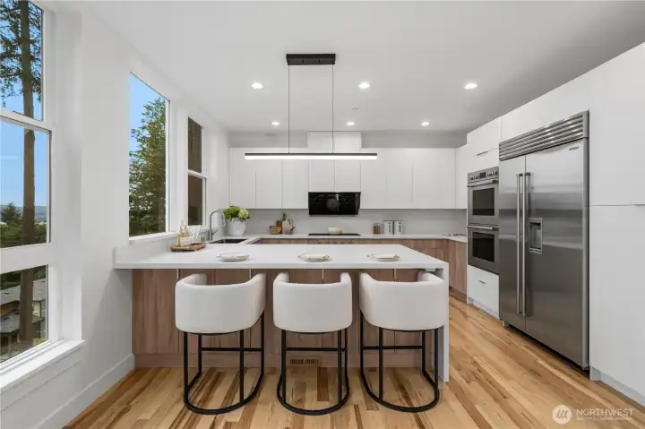 Spacious chef's kitchen with oversized waterfall island and top-line appliances
