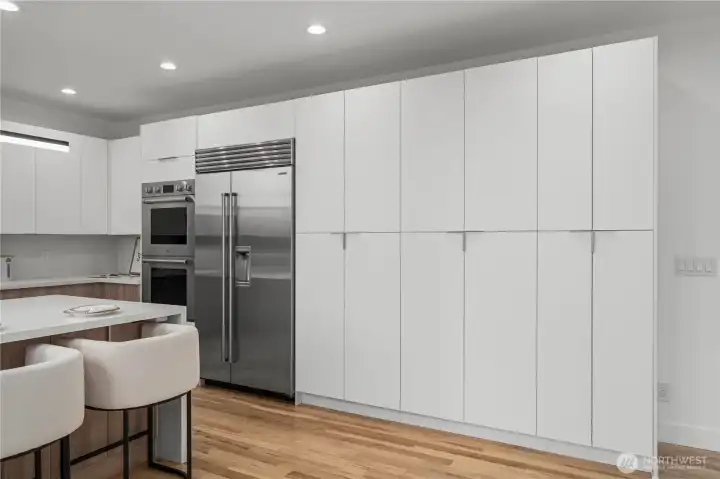 Sub Zero refrigerator and exceptional storage throughout the kitchen