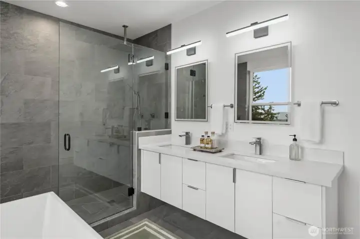 The spa-inspired ensuite features a freestanding soaking tub, oversized walk-in shower, dual vanities, and a generous walk-in closet