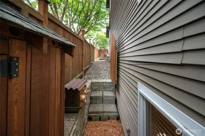 Off the front patio is a side yard to store waste containers or a dog run.