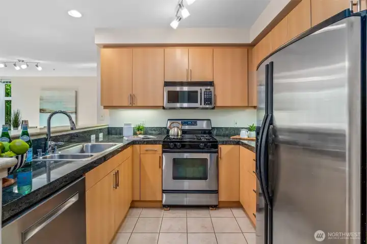 Stone counters, stainless appliances, and a gas stove. (Gas included in HOAs.) Ample cabinets, but there's also a floor-to-ceiling pantry (not shown). Stone counters, stainless appliances, and a gas stove. (Gas included in HOAs.) Ample cabinets, but there's also a floor-to-ceiling pantry (not shown).