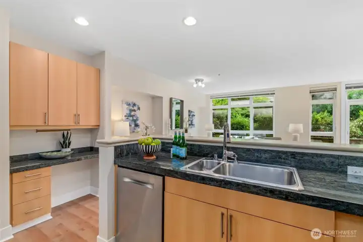 To left of kitchen is a built-in desk/workspace, with extra overhead cabinets. To left of kitchen is a built-in desk/workspace, with extra overhead cabinets.