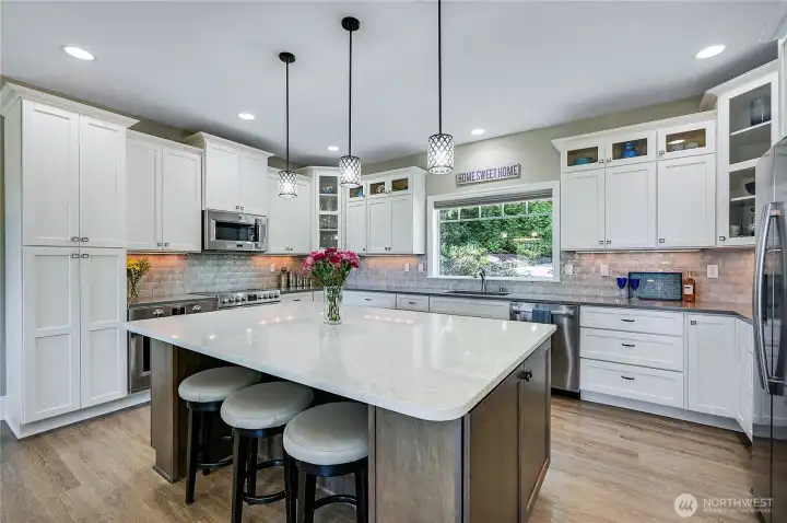 The large island features seating, additional cabinet storage and almost unlimited counter space.