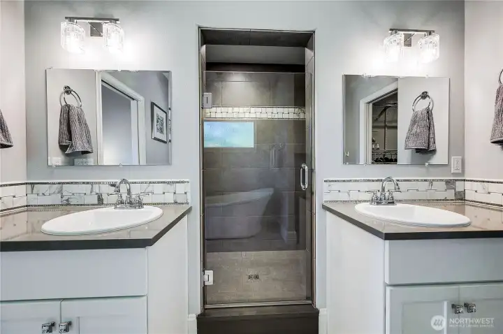 Double vanities is always nice, the glass door takes you a spacious shower with double shower heads.