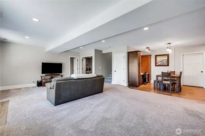 The lower-level family room, that is a seating area with a sink, microwave and fridge.