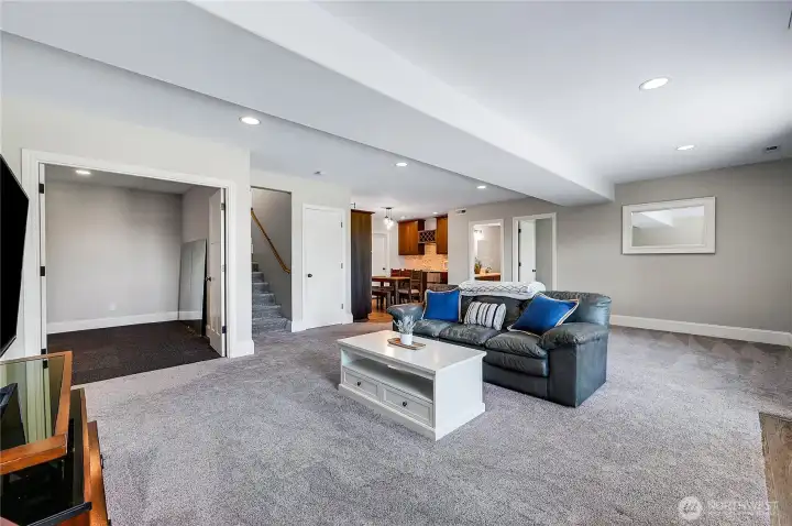 The family room has plenty of space for media and game space, maybe a pool table. The French doors on the left go to the workout room.
