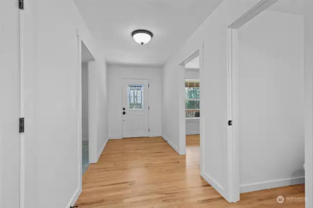 wide hallway with hardwood floors upon entry