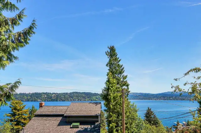 Wow, what a view !!!! Outstanding Lake Washington, Mercer Island and Cascade Mountain view from the huge front deck off the living room. This is the view from the living room and Primary Bedroom.  Awesome.
