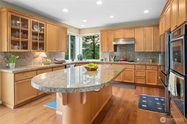 Island kitchen has stainless appliances including double ovens.  All appliances convey.