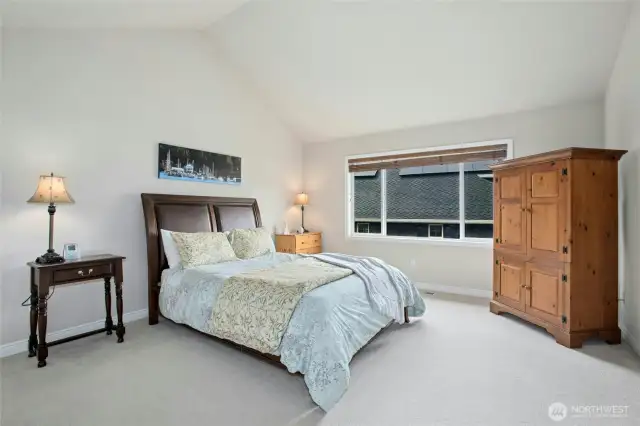 Primary bedroom features vaulted ceilings, double walk-in closets and adjacent five piece primary bathroom.