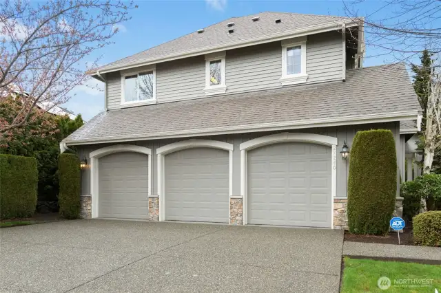 Large driveway leads to spacious three-car garage.