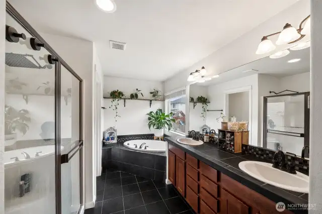 Primary ensuite with large soaking tub, double vanity & walk in shower.