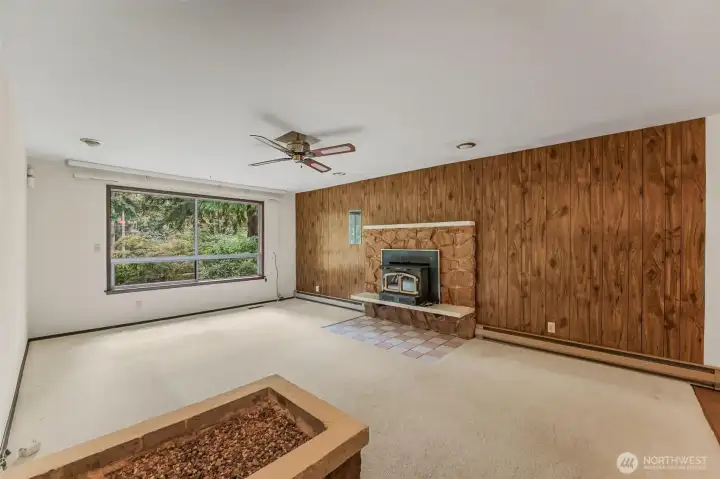 Living room with wood burning insert fireplace.