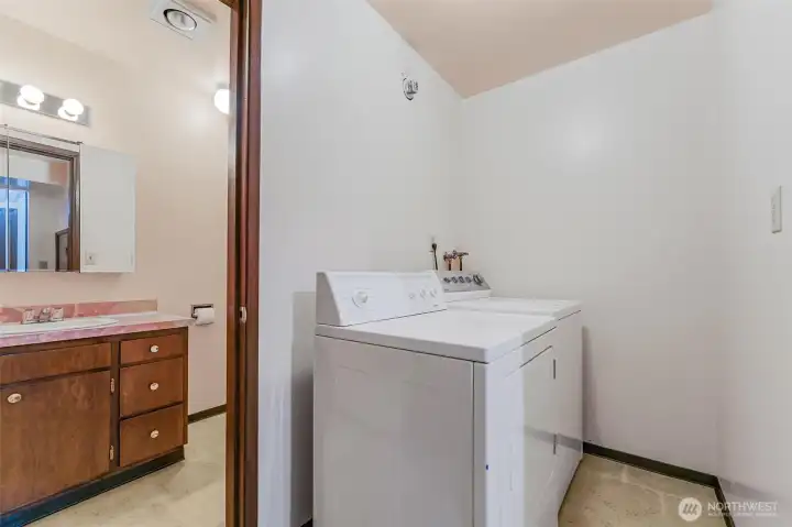 Utility room includes washer and dryer.